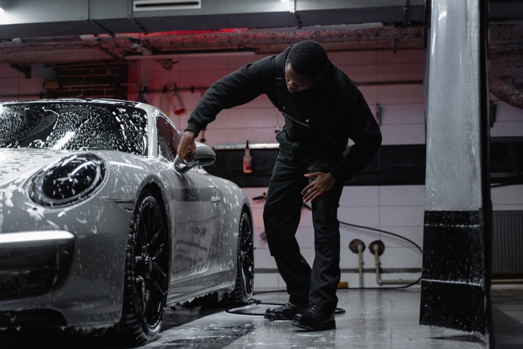 A man washing a car. 